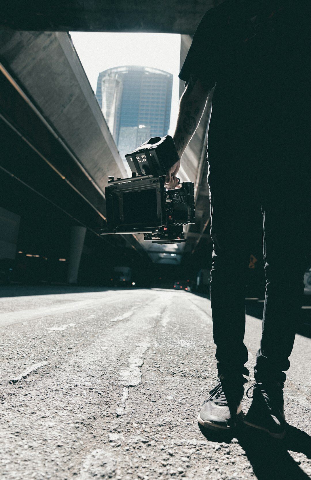 Journalist filming a report with a compact camera on a city street